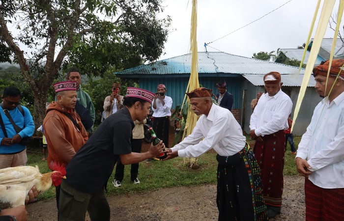 Ketua PWMB Marselus Pahun (kiri) menerima bir dari tua adat Langgo, saat rombongan PWMB tiba di Desa Wae Lolos Mabar NTT, Kamis (8/2/2024), dalam rangka peringatan HPN 2024