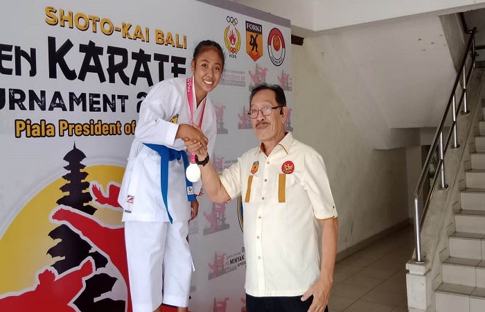 Siswi kelas 9 SMPN I Alok Timur Elisabeth F. Rodriques menerima medali emas dari panitia dalam kejuaraan Kata Perorangan dan Komite Cadet di kelas 54 untuk perlombaan Shotokai  Bali Open pada Juli 2023. Foto Dokumen Pribadi