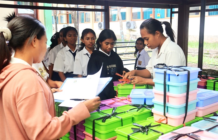 Para siswa SMPK Frateran Maumere, Kabupaten Sikka, NTT, mengambil makanan bergizi gratis di Taman Bacaan Masyarakat, Selasa (18/2/2025).(FOTO : EBED DE ROSARY).