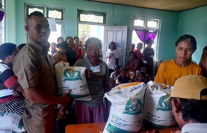 Sekdes Pocolia, Faldus Cen (kiri) menyerahkan bantuan beras pangan kepada warga Desa Pocolia.